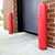 Red bollards flanking a roll-up door on a brick building