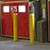 Row of red dock doors with yellow bollards