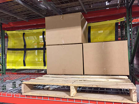 rack safety straps with mesh panel installed on a pallet rack
