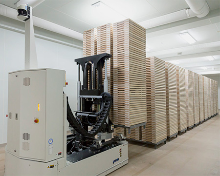 automated guided vehicle with a stack of skids