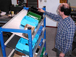 Worker picking from tilt shelf