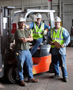 Workers gathered around a forklift