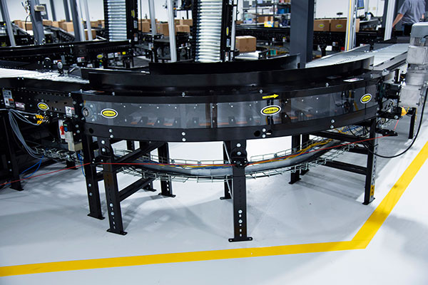conveyor line with belted curve