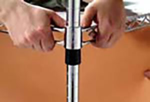 hands sliding shelf over post sleeve