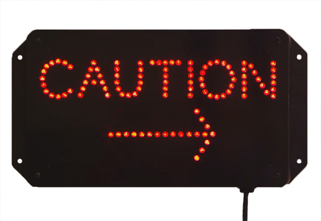 digital warning sign with red caution text and arrow