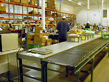 Shipping Station: Workers sort bin-stored product and release to the conveyor system so it can be put away.