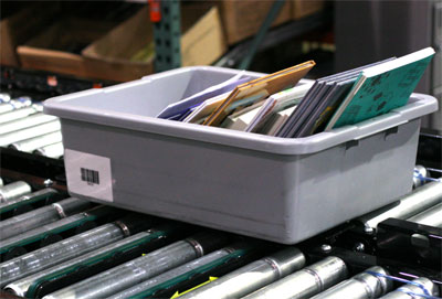 Tote with books on EDC's conveyor system