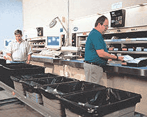 workers operating vertical carousel